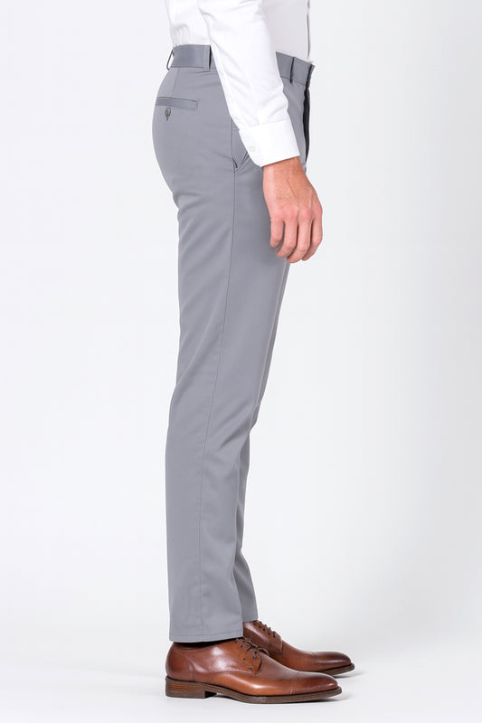 Gray pants worn with a white shirt and brown shoes on a white background