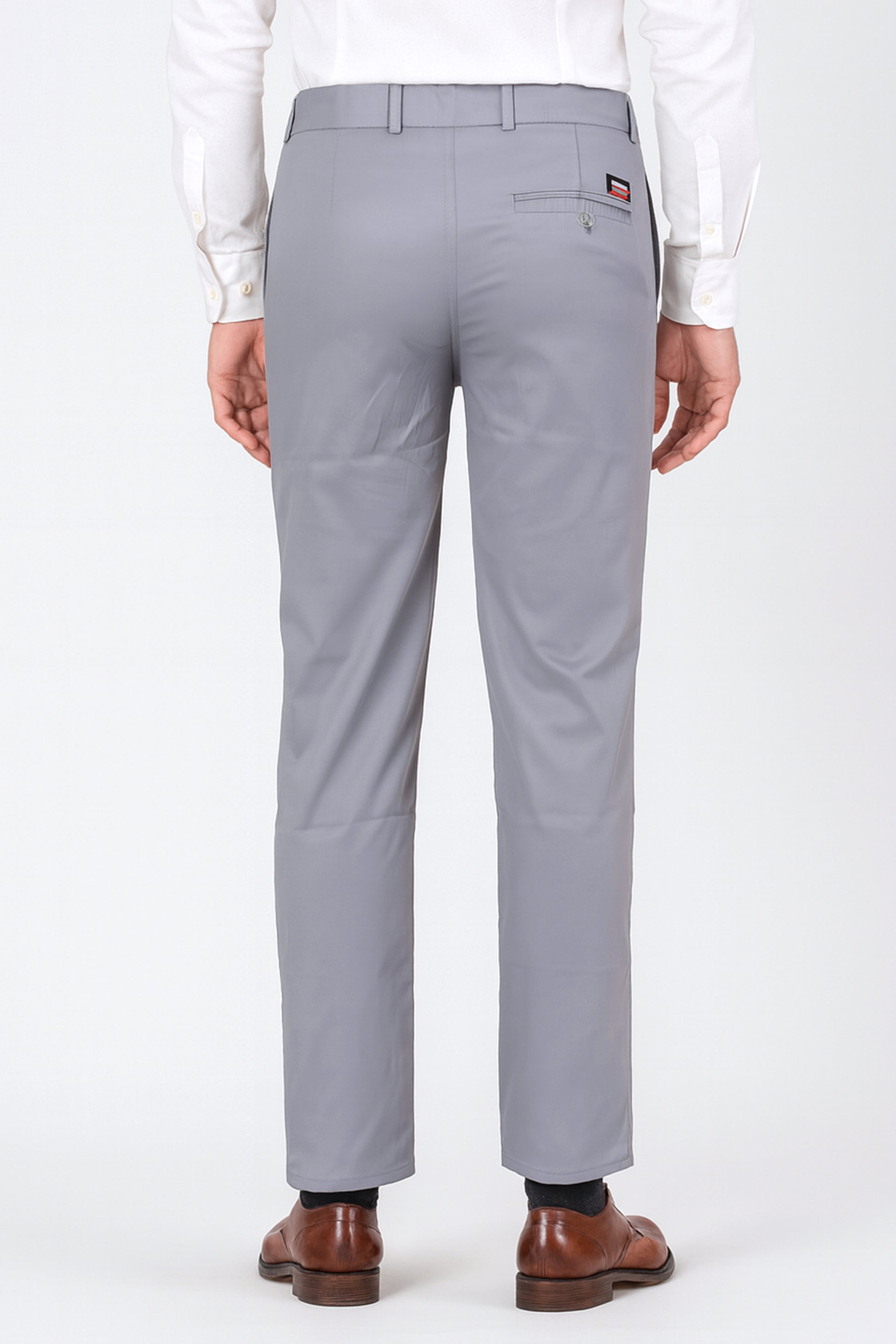 Gray pants worn by a person on a white background