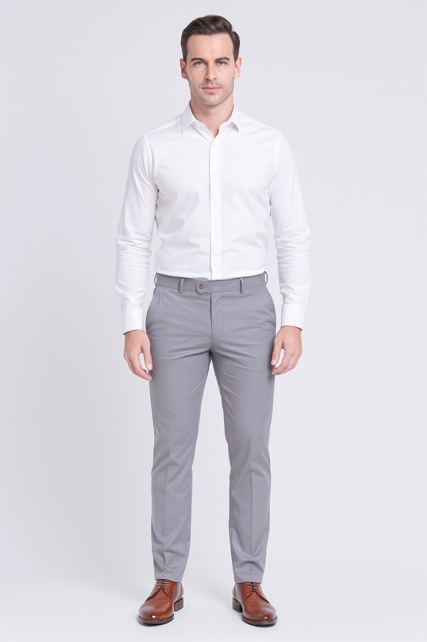 Man wearing a white dress shirt and gray pants on a white background