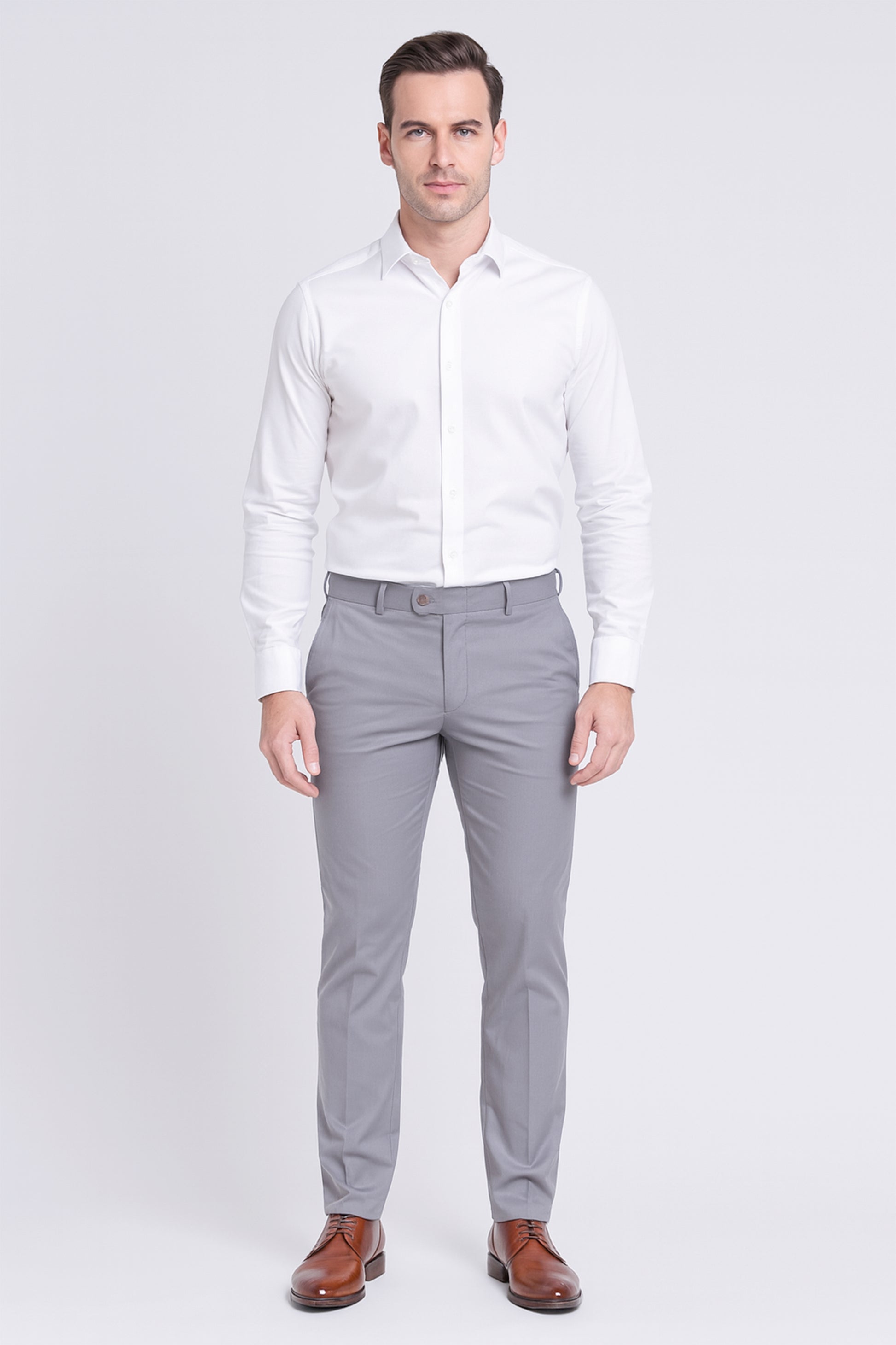 Man wearing a white dress shirt and gray pants on a white background