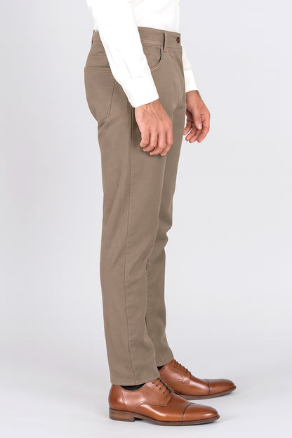 Beige pants worn by a person on a white background
