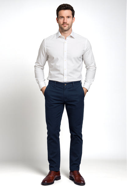 Man wearing a white dress shirt and navy pants on a white background