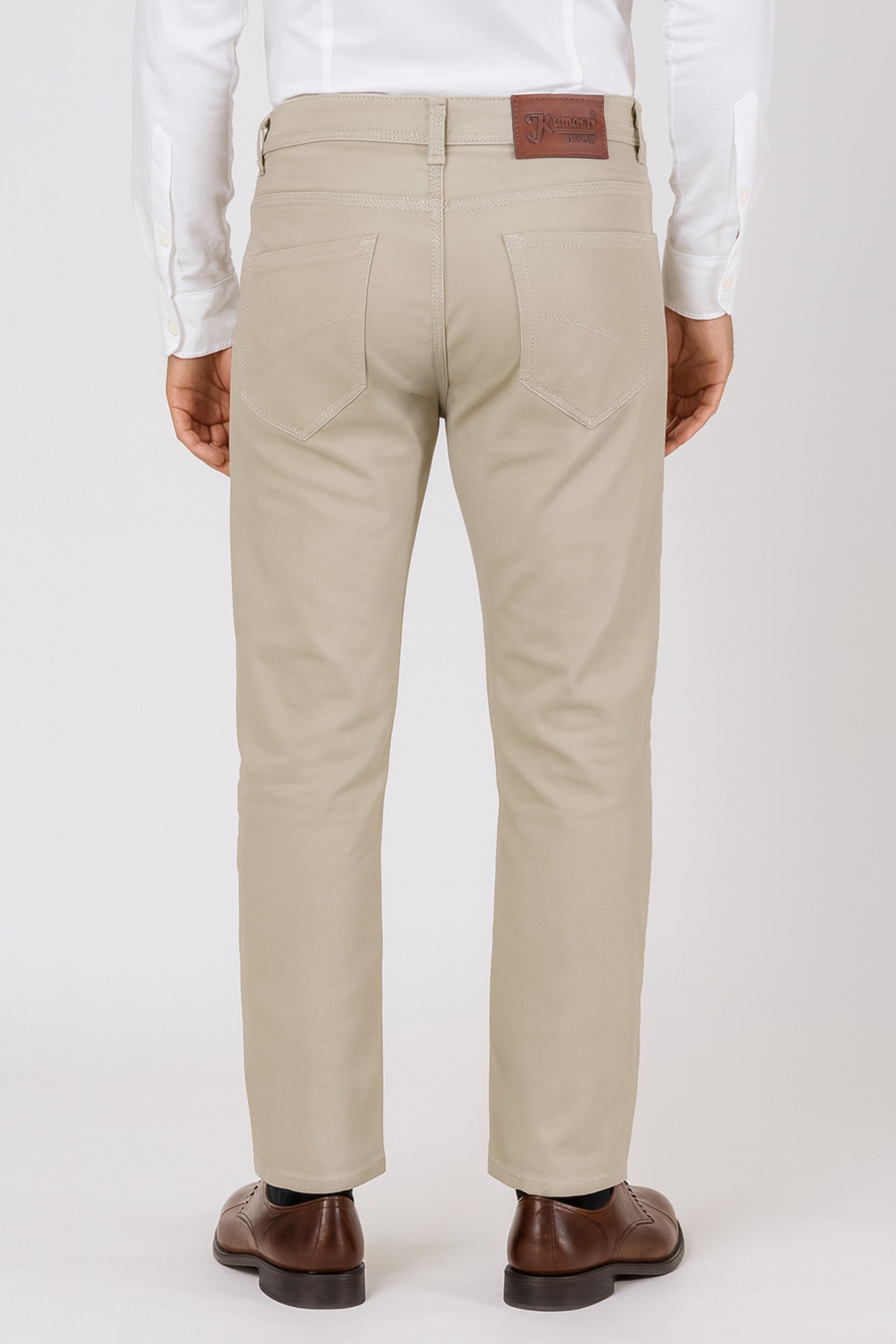 Beige pants with a brown belt and white shirt on a white background