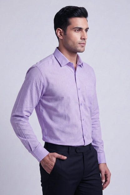 Man wearing a light purple dress shirt and black pants on a light gray background