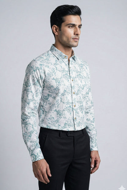 Man wearing a patterned shirt and black pants on a gray background