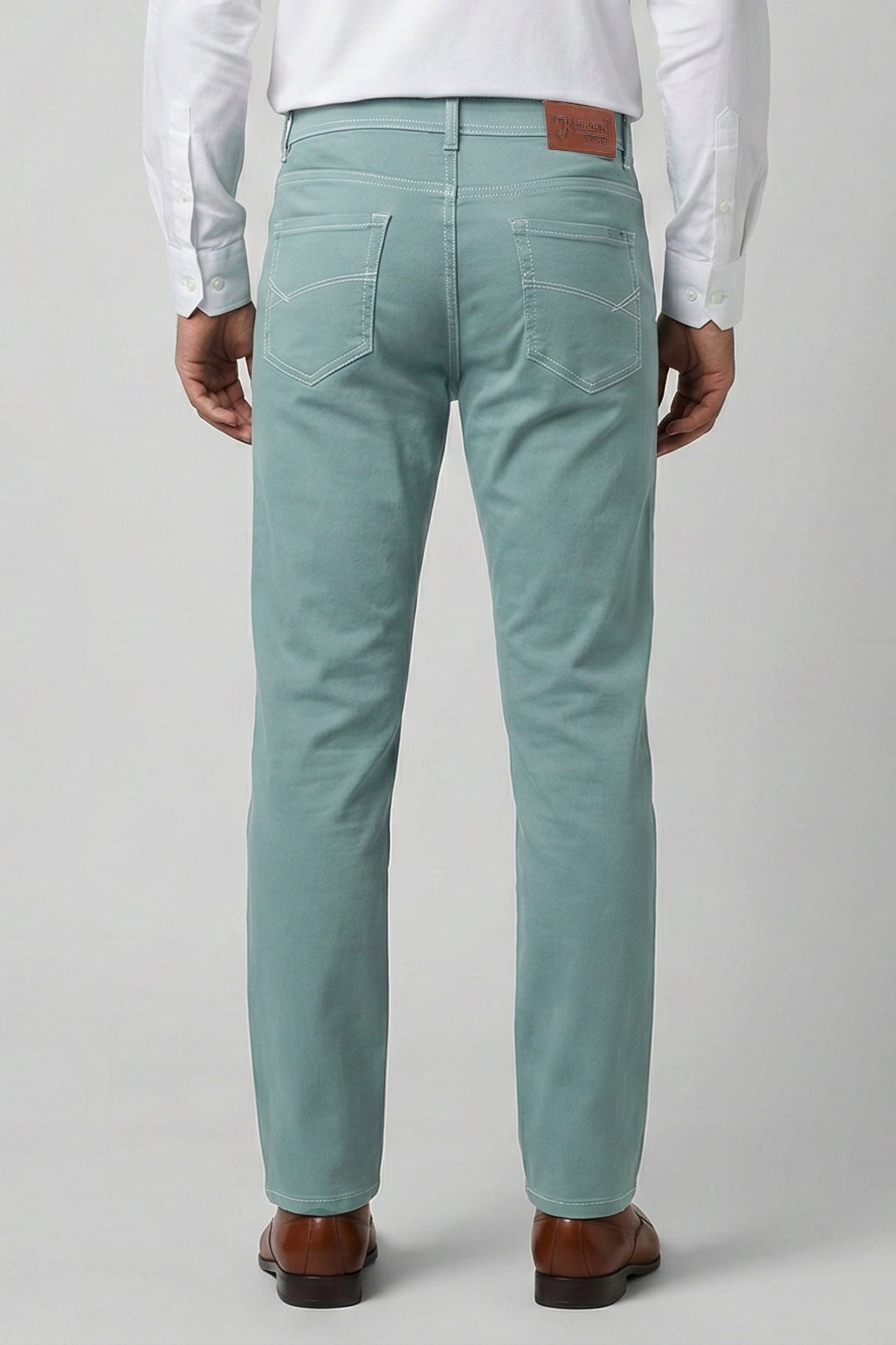 Light blue jeans worn by a person on a plain background