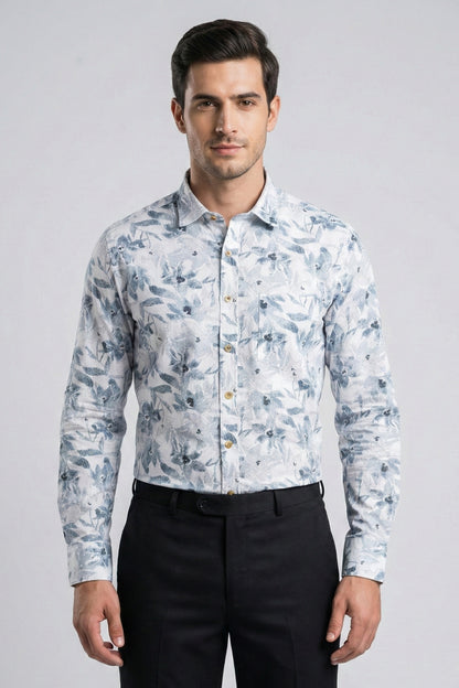 Man wearing a light blue floral patterned shirt against a gray background