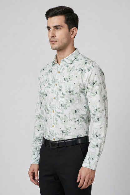 Man wearing a floral patterned shirt with black pants on a gray background