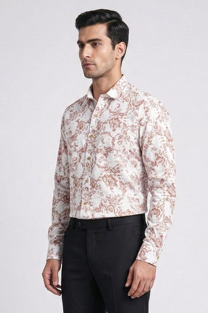 Man wearing a patterned shirt and black pants on a white background