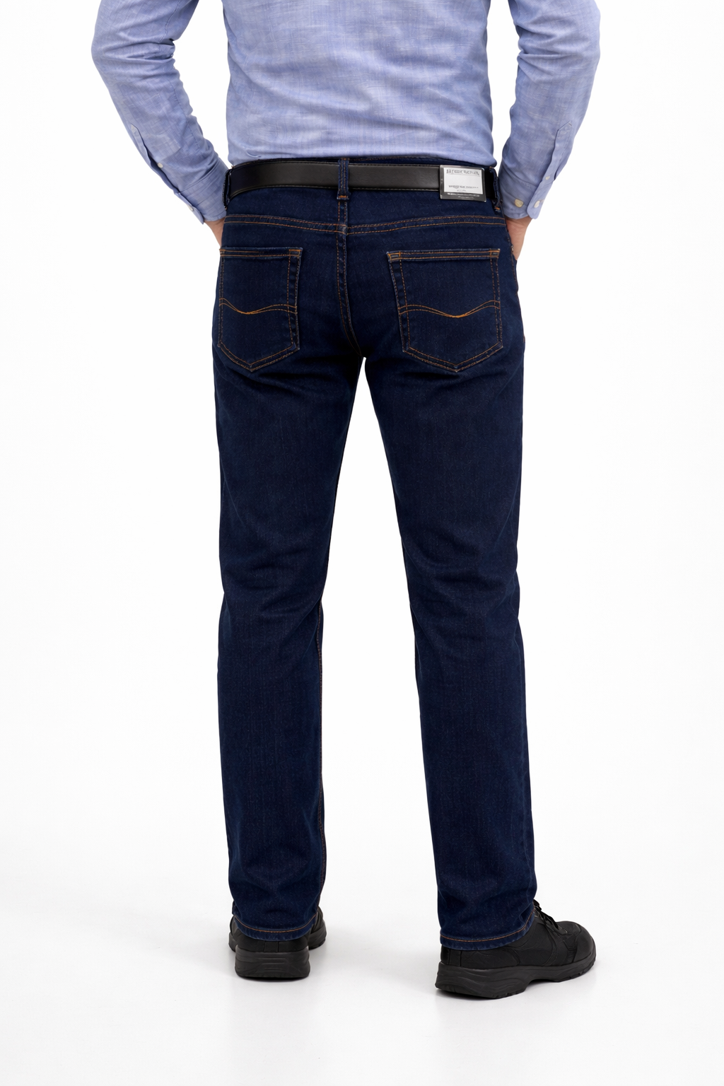 Person wearing dark blue jeans and a light blue shirt on a white background