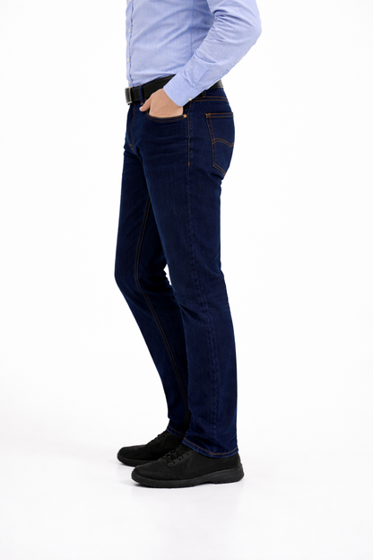 Person wearing dark blue jeans and black shoes on a white background