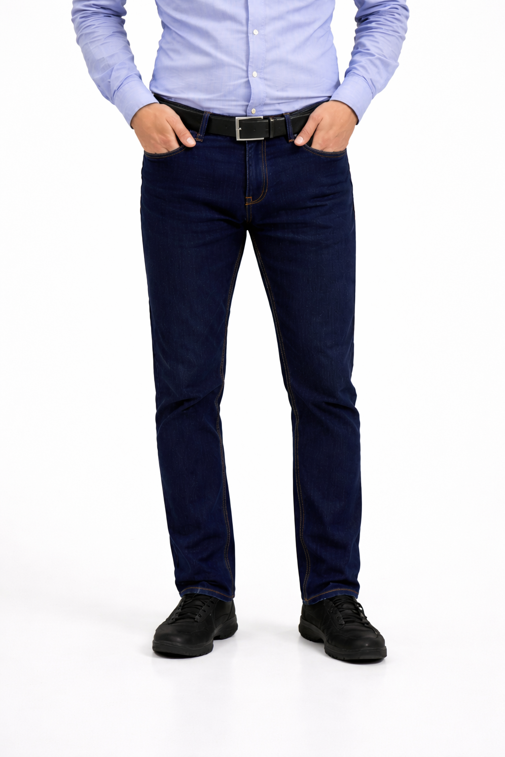 Person wearing a light blue shirt, dark blue jeans, and black shoes on a white background