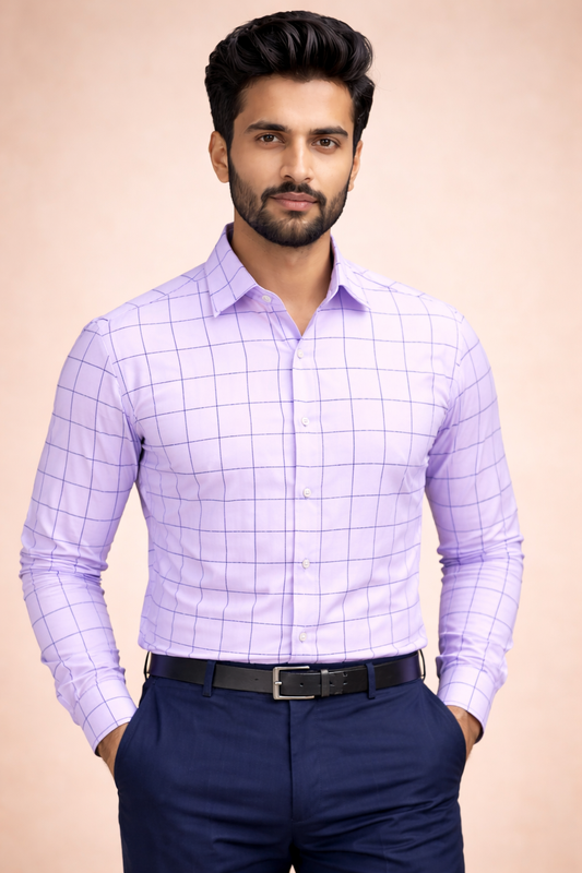 Man wearing a light purple checkered shirt and dark blue pants on a beige background